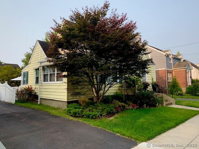 345 Courtland Avenue Bridgeport, CT 06605 - Photo 36 of 38 a front view of a house with a garden
