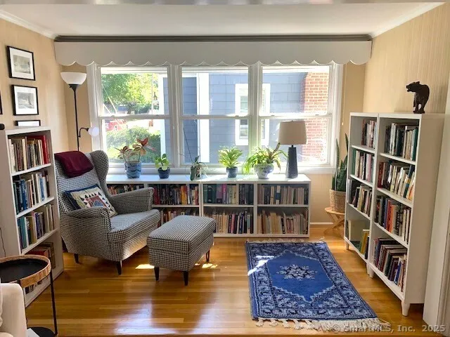 a living room with furniture and a book shelf