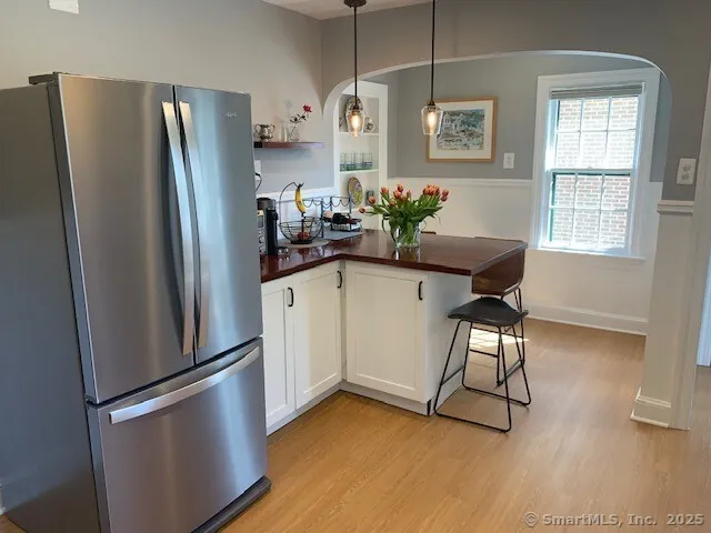 a kitchen with stainless steel appliances granite countertop a refrigerator and a sink