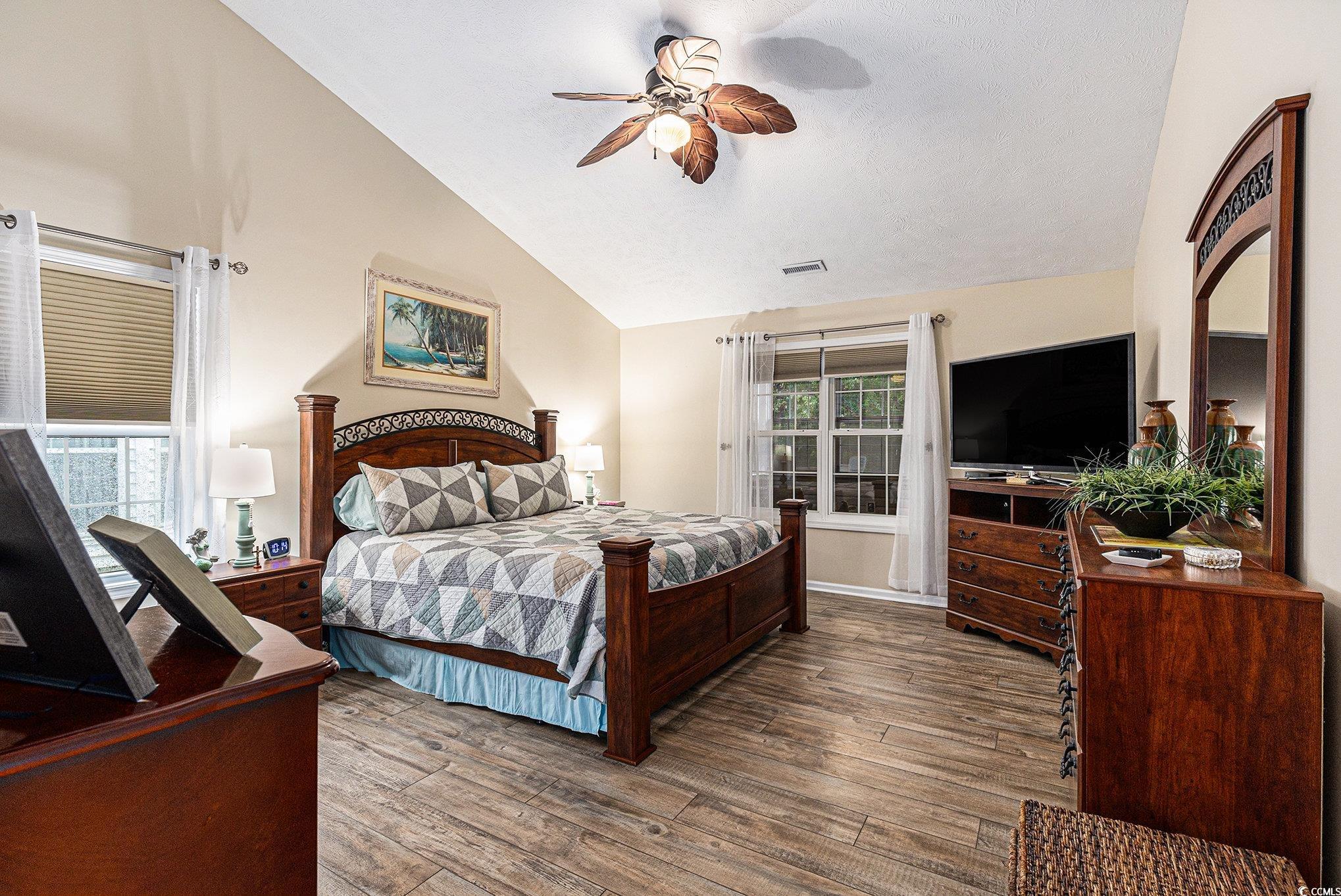 1105 Lampwick Lane Murrells Inlet, SC 29576 - Photo 20 of 40 Bedroom with vaulted ceiling, wood finished floors, and a ceiling fan