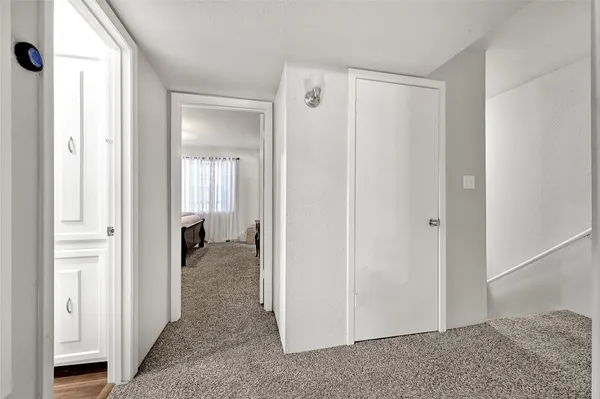 a bedroom with a bed and a mirror