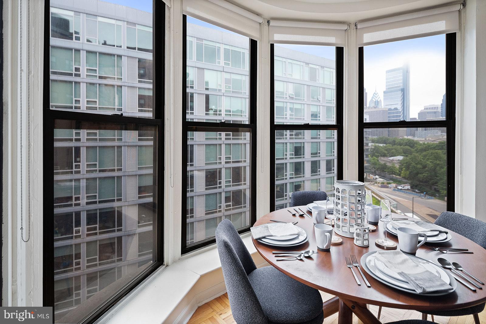 2201 Pennsylvania Avenue, Unit 1112 Philadelphia, PA 19130 - Photo 8 of 45 a view of a dining room with furniture window and wooden floor