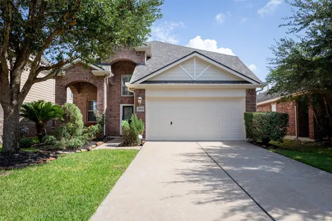 a front view of a house with a yard and a garage