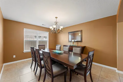 a view of a dining room with furniture and a chandelier