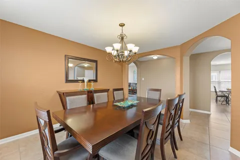 a dining room with furniture and chandelier