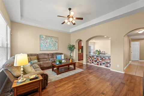 a living room with furniture and wooden floor