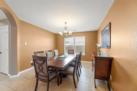 a view of a dining room with furniture and window