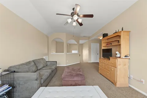 a living room with furniture and a chandelier