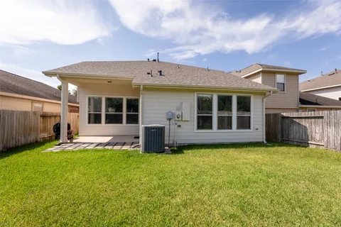 a view of a house with a yard and sitting area