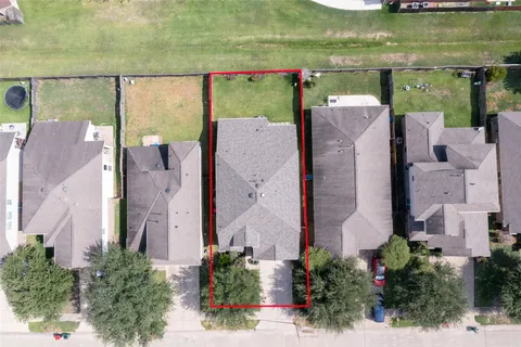 an aerial view of a house with a yard basket ball court and outdoor seating