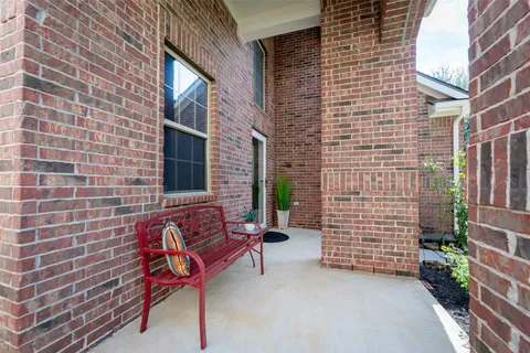 a brick building with a bench in front of it