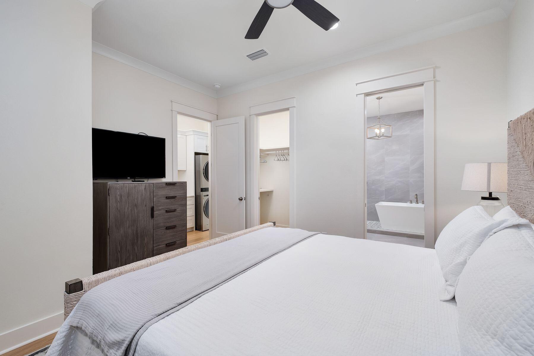 1979 Baytowne Loop Miramar Beach, FL 32550 - Photo 18 of 35 a bedroom with a bed and a flat tv screen on wall