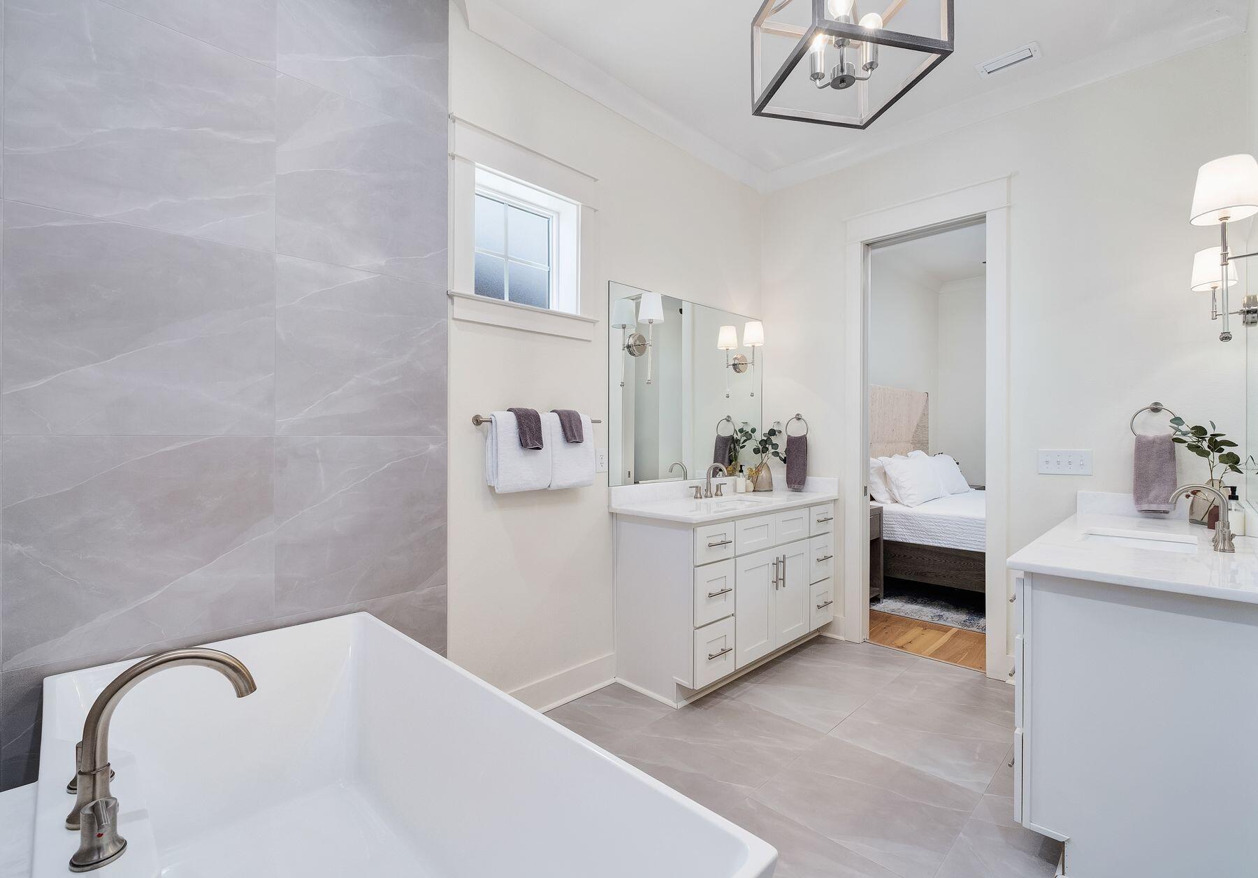 1979 Baytowne Loop Miramar Beach, FL 32550 - Photo 20 of 35 a spacious bathroom with a double vanity sink a mirror and a bathtub
