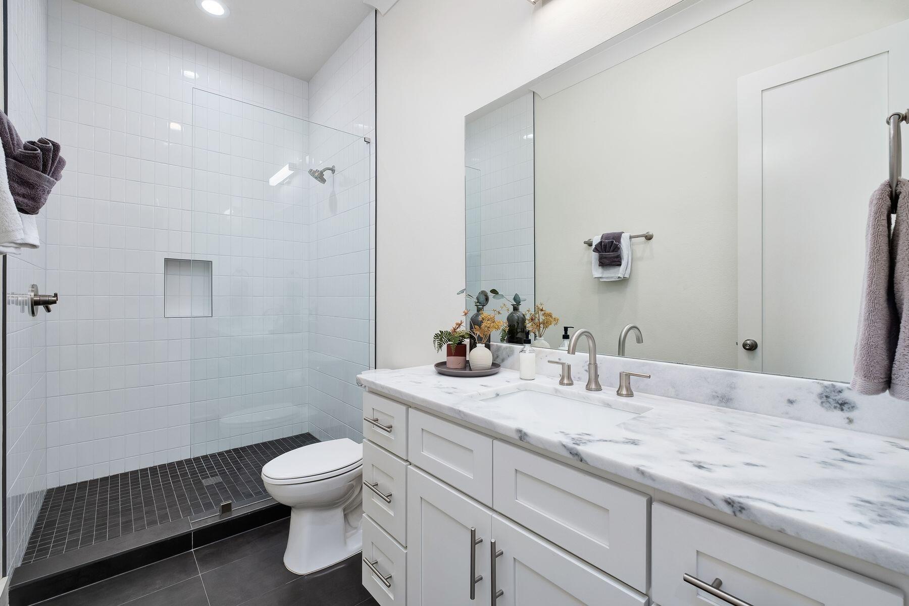 1979 Baytowne Loop Miramar Beach, FL 32550 - Photo 26 of 35 a bathroom with a granite countertop toilet a sink and a mirror