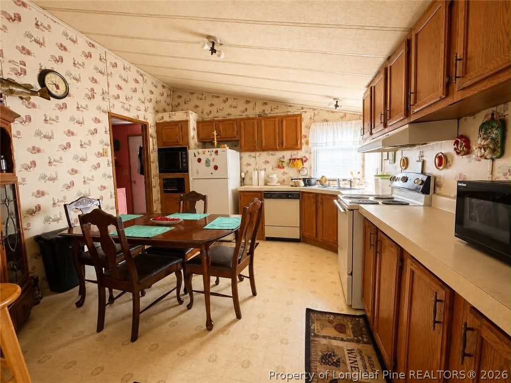4435 Tartt's Mill Road Wilson, NC 27893 - Photo 7 of 23 a view of a kitchen with kitchen island granite countertop a table and chairs in it
