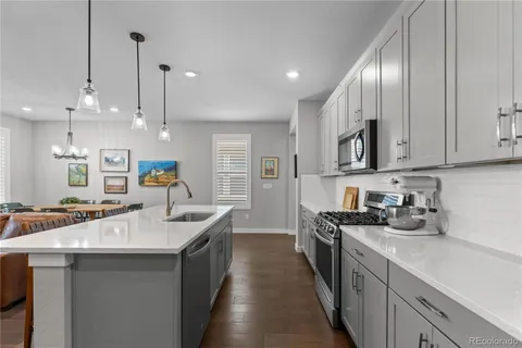 a kitchen with stainless steel appliances a sink stove and cabinets