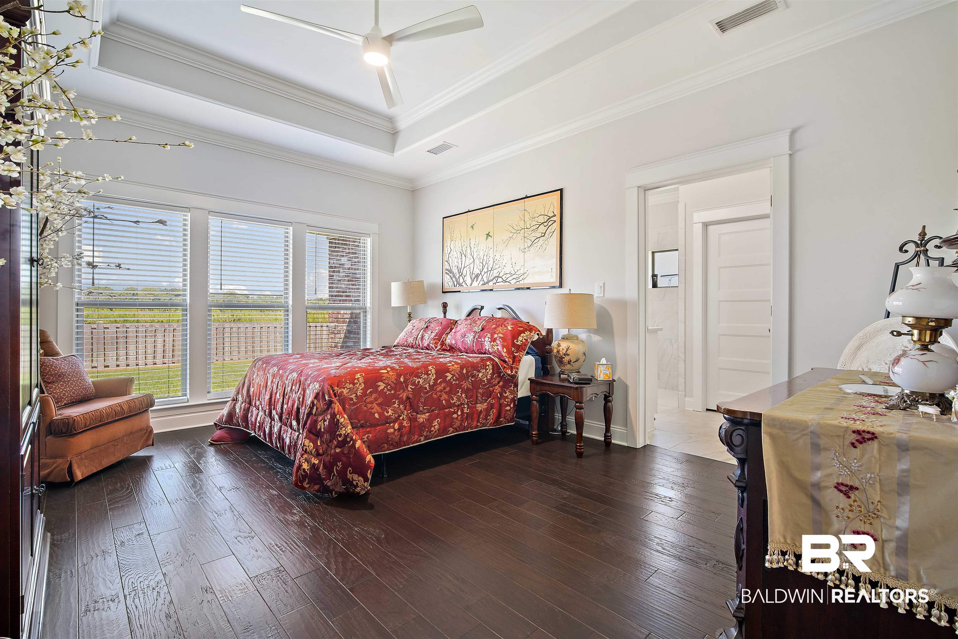 969 Charleston Loop Fairhope, AL 36532 - Photo 15 of 30 Bedroom with ceiling fan, a raised ceiling, ornamental molding, and hardwood / wood-style flooring