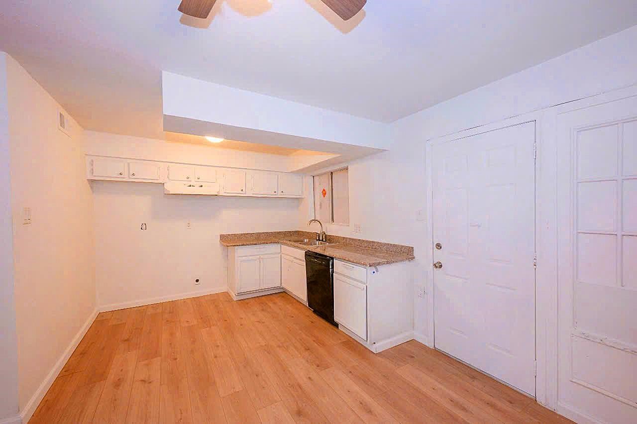 12048 Beechnut Street Houston, TX 77072 - Photo 7 of 13 a kitchen with a sink and wooden floor