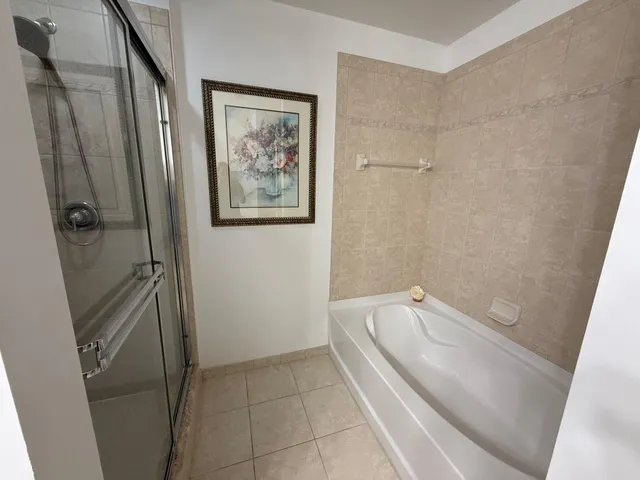 a bathroom with a tub and shower