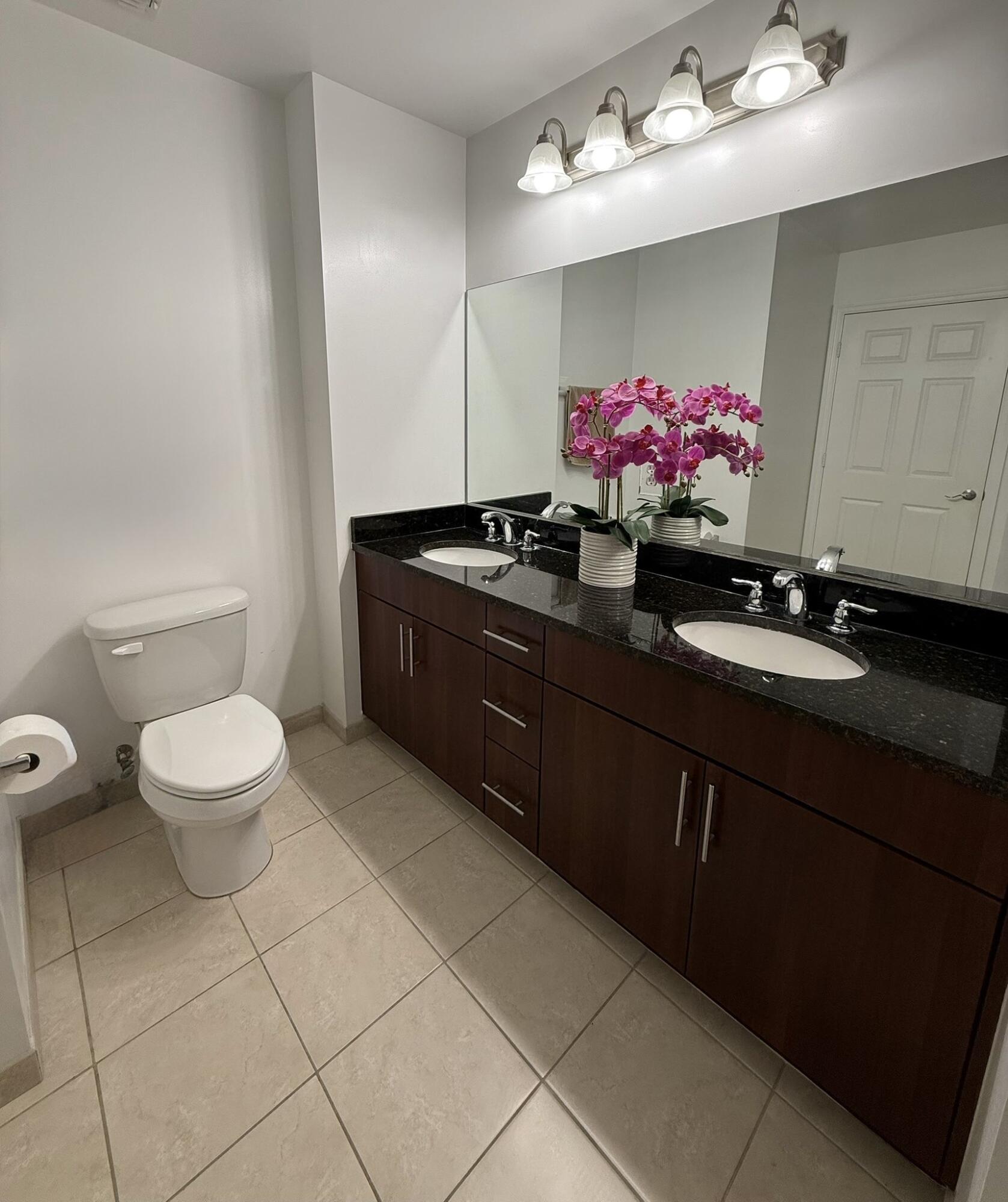 4905 Midtown Lane, Unit 2405 Palm Beach Gardens, FL 33418 - Photo 14 of 28 a bathroom with a sink vanity and toilet