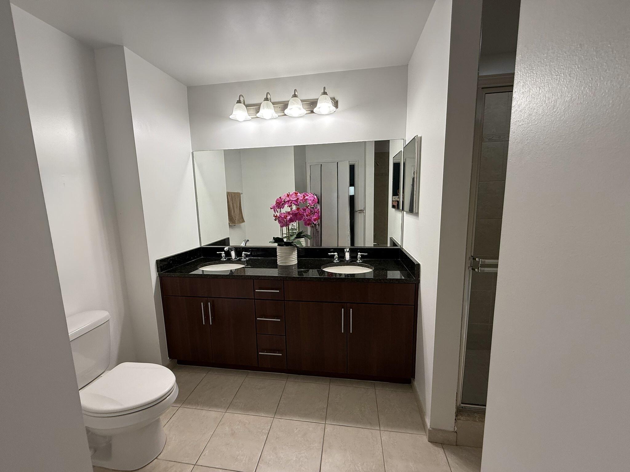 4905 Midtown Lane, Unit 2405 Palm Beach Gardens, FL 33418 - Photo 15 of 28 a bathroom with a sink vanity and a mirror