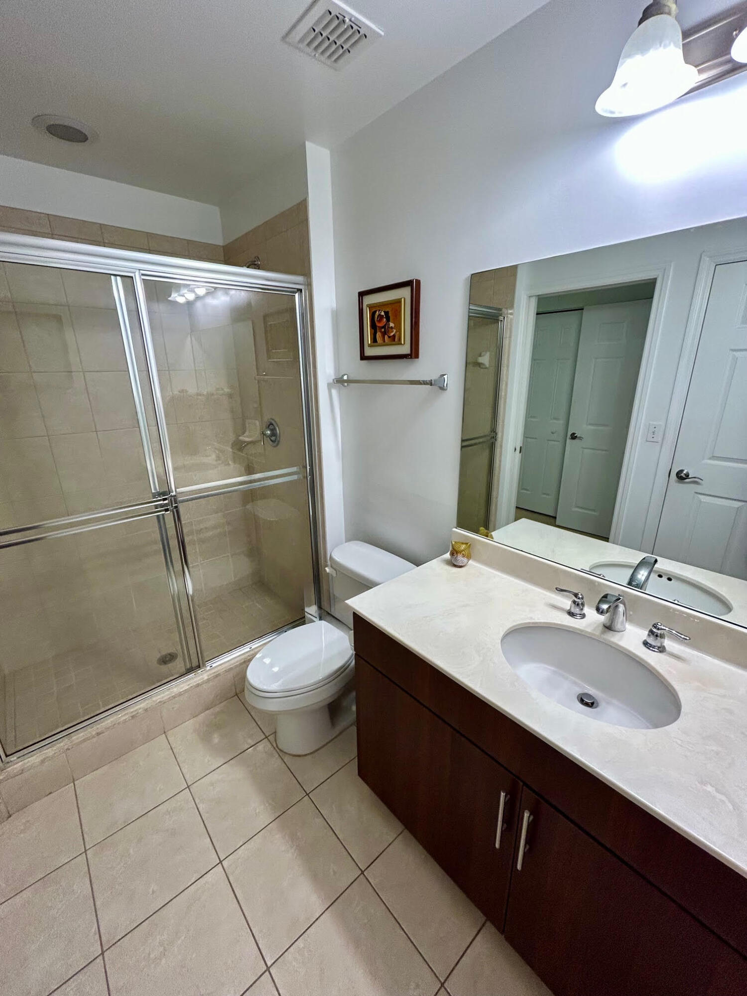 4905 Midtown Lane, Unit 2405 Palm Beach Gardens, FL 33418 - Photo 17 of 28 a bathroom with a sink toilet and shower