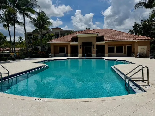 a view of a house with pool and a yard
