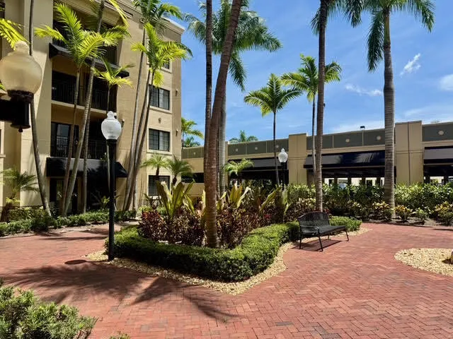 a view of multiple house with palm trees