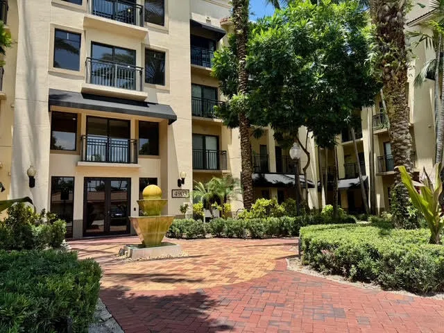 a front view of a building with a garden