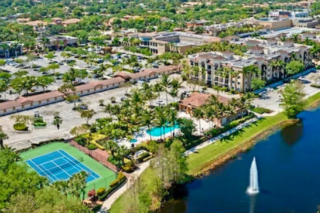 an aerial view of residential houses with outdoor space and swimming pool