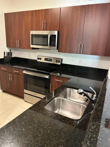 a kitchen with a sink and a microwave