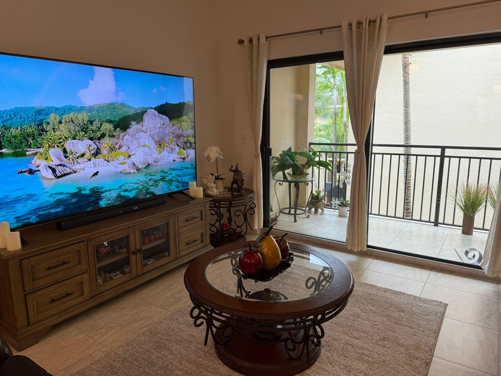 4905 Midtown Lane, Unit 2405 Palm Beach Gardens, FL 33418 - Photo 10 of 28 a living room with furniture and a floor to ceiling window
