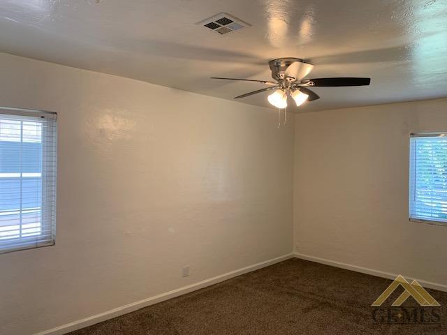 Undisclosed Address Bakersfield, CA 93304 - Photo 12 of 32 an empty room with a window and a fan