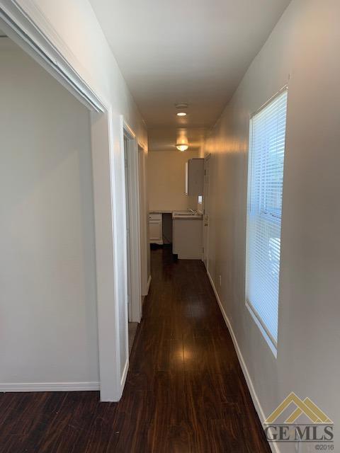 Undisclosed Address Bakersfield, CA 93304 - Photo 16 of 32 a view of a hallway with wooden floor and furniture