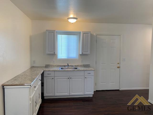 Undisclosed Address Bakersfield, CA 93304 - Photo 18 of 32 a kitchen with a sink cabinets and wooden floor