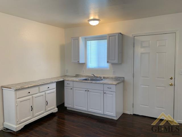 Undisclosed Address Bakersfield, CA 93304 - Photo 19 of 32 a view of cabinets a wooden floor and a sink