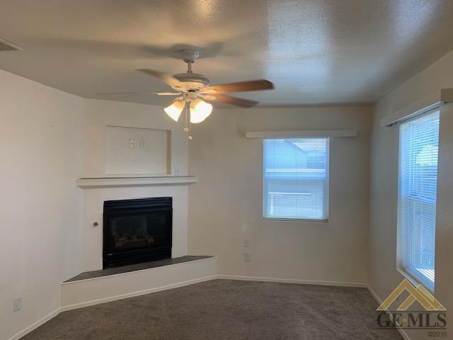 Undisclosed Address Bakersfield, CA 93304 - Photo 20 of 32 an empty room with windows and fireplace