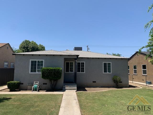 Undisclosed Address Bakersfield, CA 93304 - Photo 2 of 32 a front view of a house with a yard and potted plants