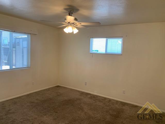 Undisclosed Address Bakersfield, CA 93304 - Photo 21 of 32 an empty room with a chandelier fan