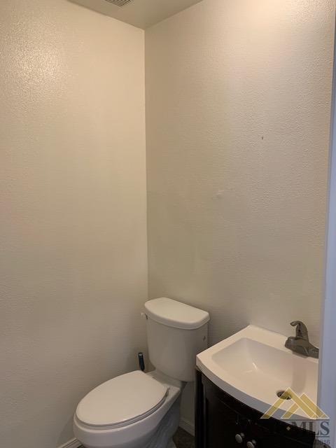 Undisclosed Address Bakersfield, CA 93304 - Photo 27 of 32 a white toilet sitting next to a bathroom sink