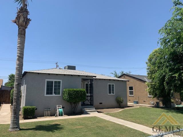 Undisclosed Address Bakersfield, CA 93304 - Photo 4 of 32 a front view of a house with a yard and potted plants