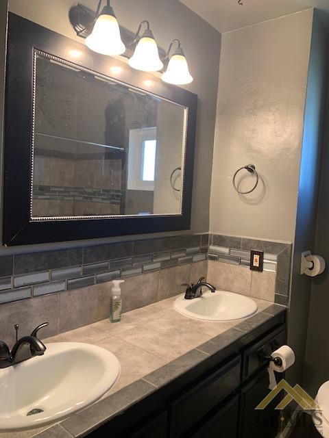 Undisclosed Address Bakersfield, CA 93304 - Photo 9 of 32 a bathroom with a sink and a mirror