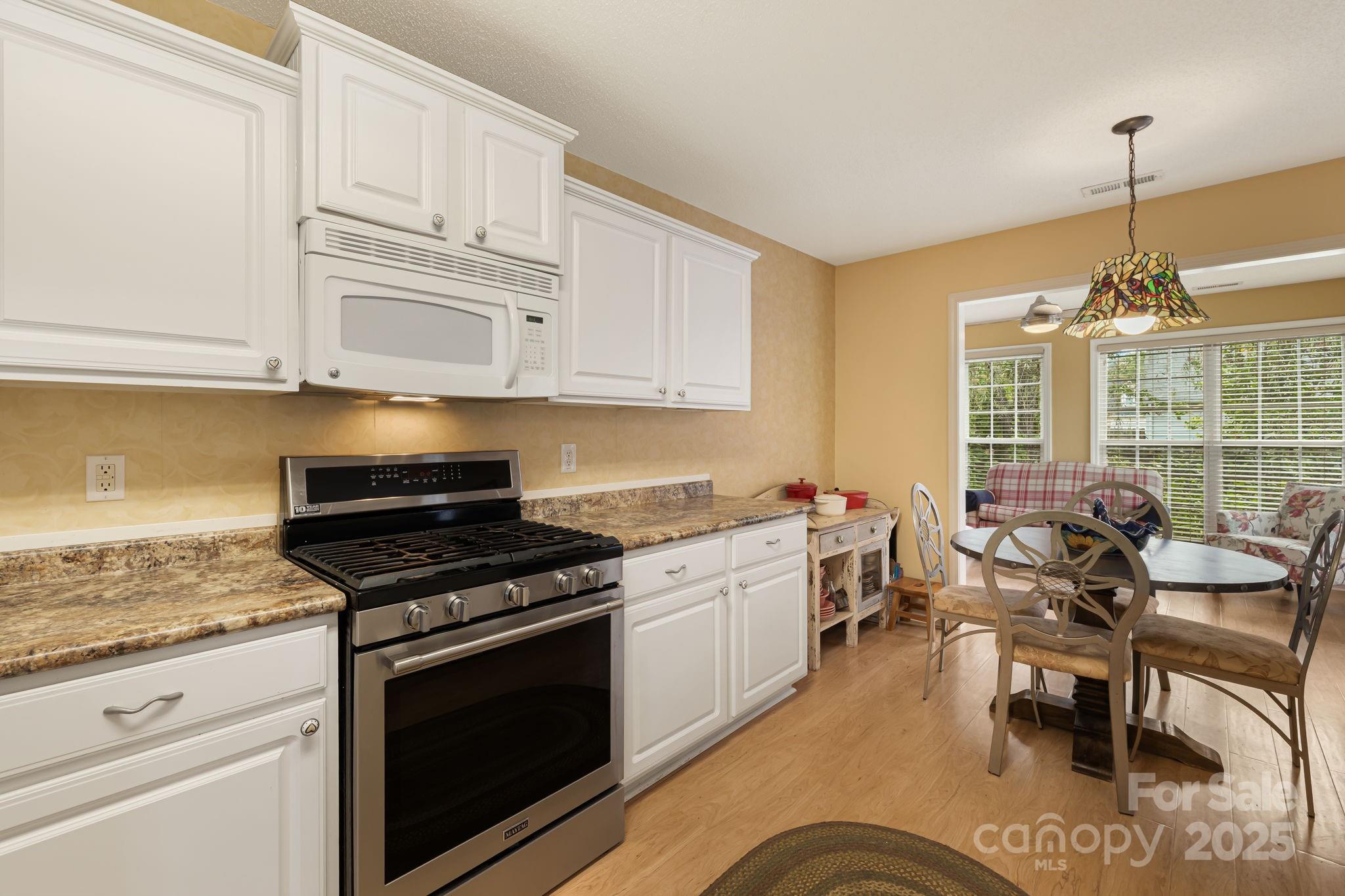 107 South Sunberry Trail Fletcher, NC 28732 - Photo 12 of 30 a kitchen with stainless steel appliances granite countertop a stove and cabinets