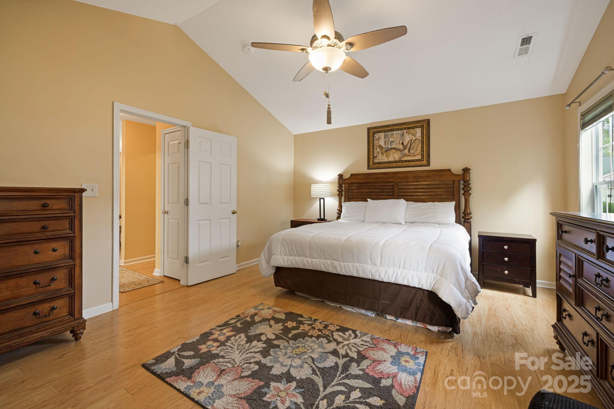 107 South Sunberry Trail Fletcher, NC 28732 - Photo 16 of 30 a bedroom with a bed and a chandelier