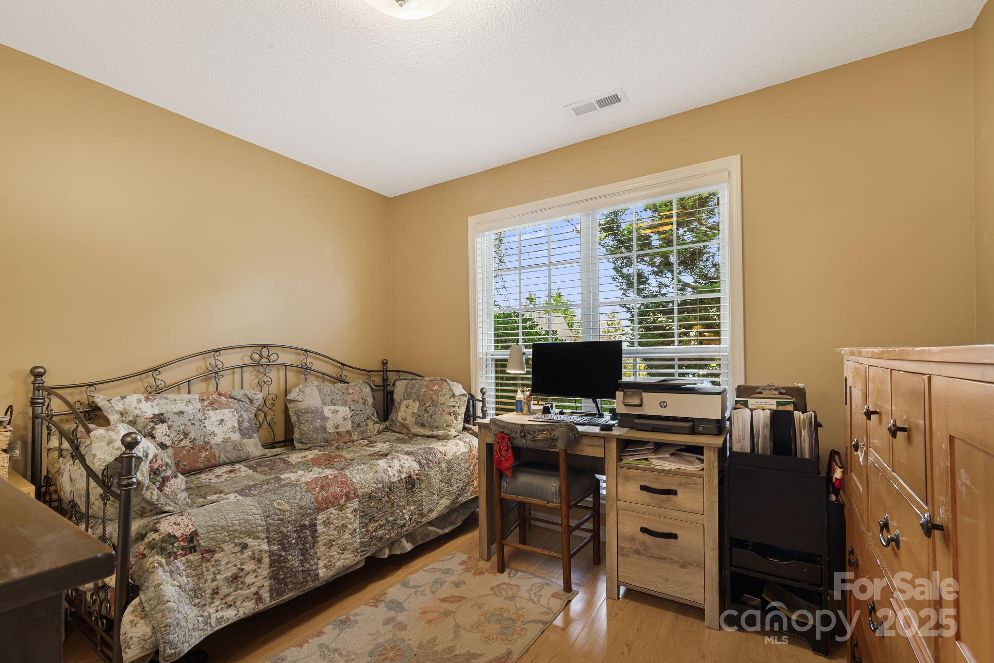 107 South Sunberry Trail Fletcher, NC 28732 - Photo 21 of 30 a bedroom with a bed and a flat screen tv