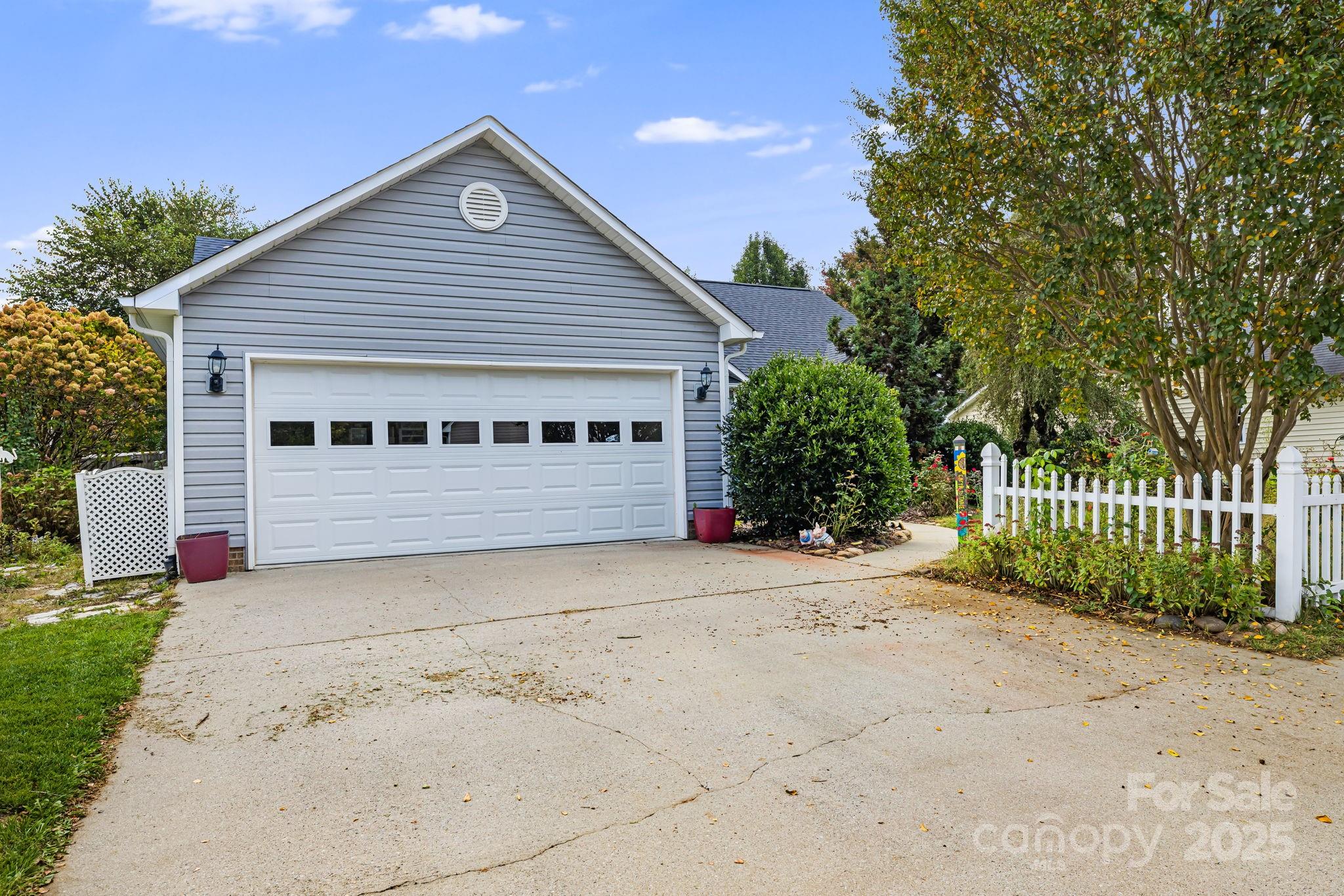 107 South Sunberry Trail Fletcher, NC 28732 - Photo 3 of 30 a view of a house with a small yard plants and large tree