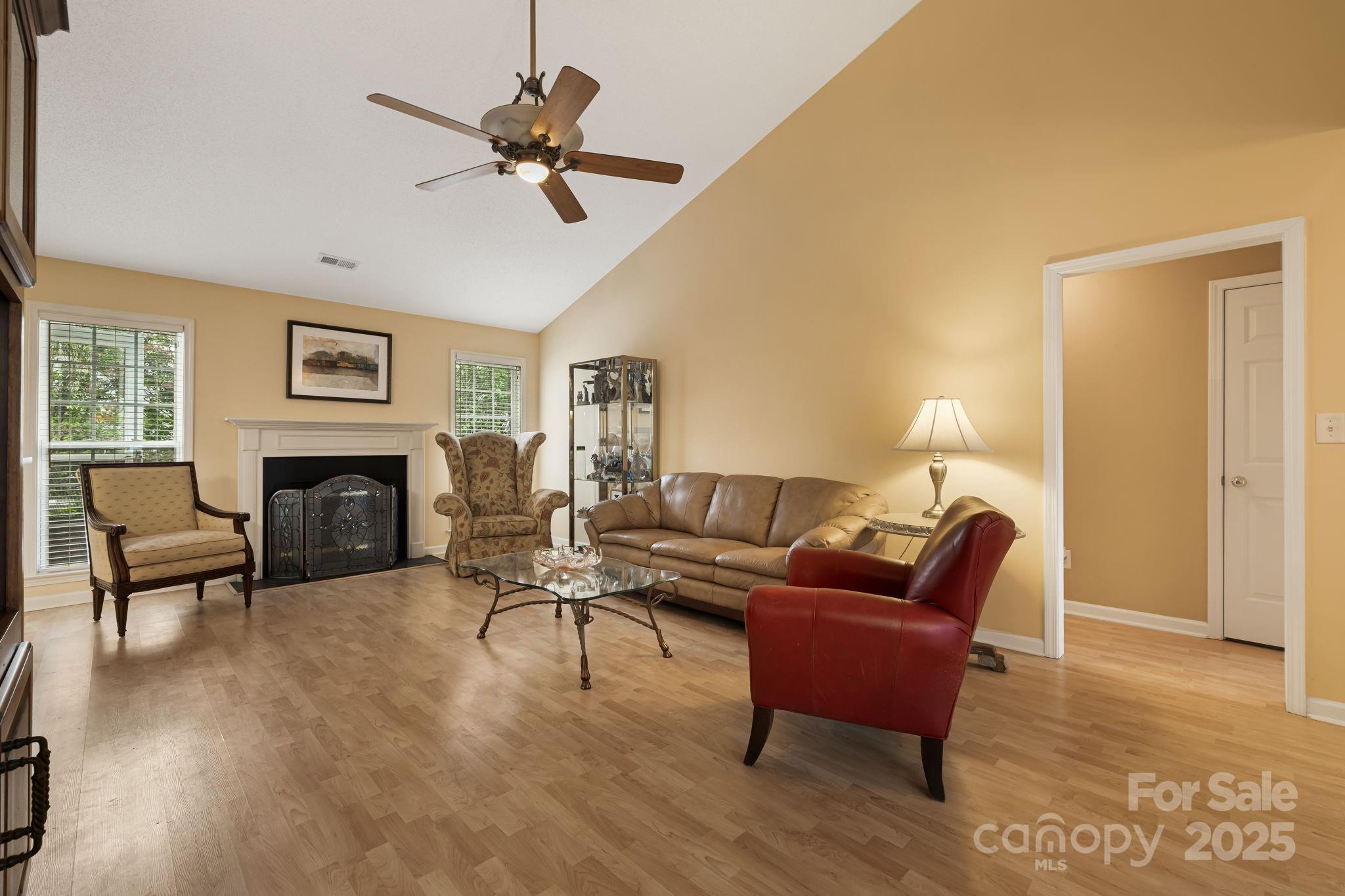 107 South Sunberry Trail Fletcher, NC 28732 - Photo 5 of 30 a living room with furniture a fireplace and a ceiling fan