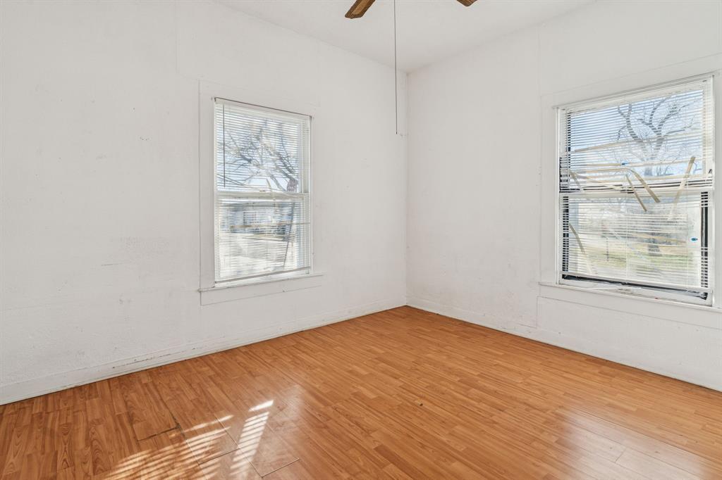 319 McKinney Street Mesquite, TX 75149 - Photo 11 of 27 a view of a big room with wooden floor and windows