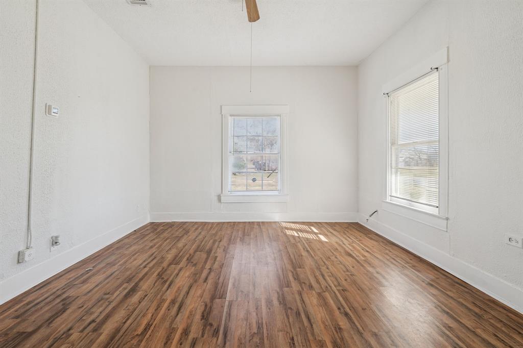 319 McKinney Street Mesquite, TX 75149 - Photo 4 of 27 an empty room with wooden floor and windows