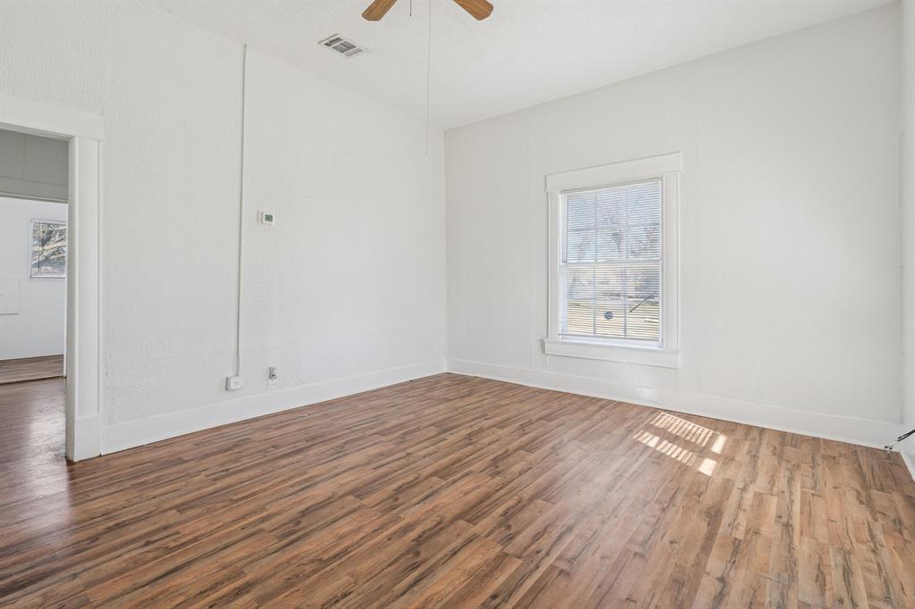 319 McKinney Street Mesquite, TX 75149 - Photo 5 of 27 a view of empty room with wooden floor and fan